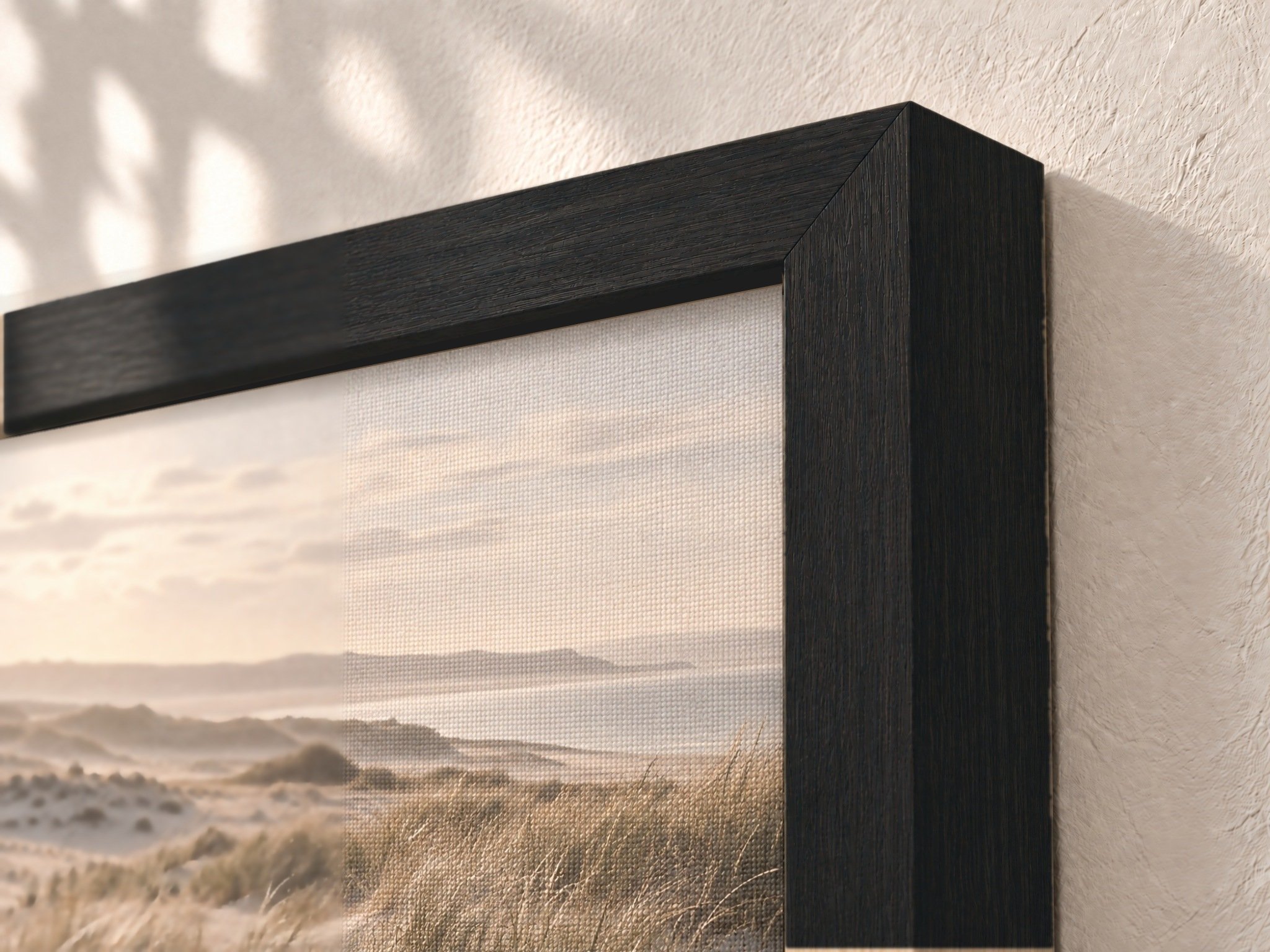 Framed Canvas Print — Black: Angled corner close-up of the Black wood veneer frame showing grain and profile