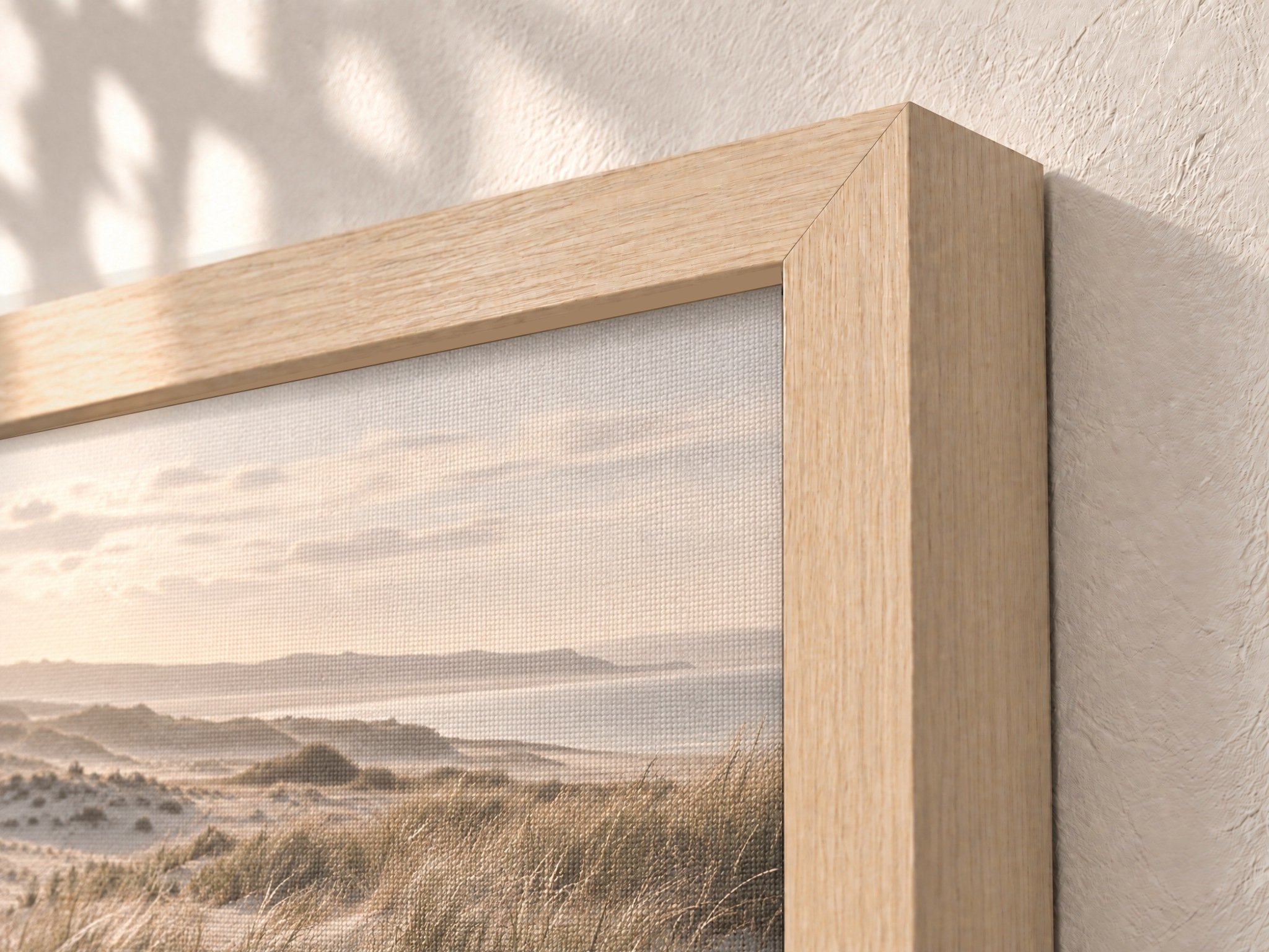 Framed Canvas Print — Light Ash: Angled corner close-up of the Light Ash wood veneer frame showing grain and profile